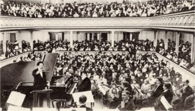 Saint-Saëns at the piano for his planned farewell concert in 1913, conducted by Pierre Monteux