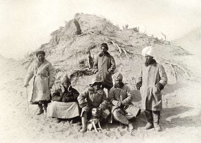 Photograph of Aurel Stein, with his dog and research team, in the Tarim Basin