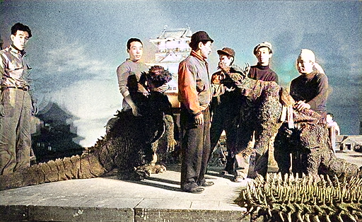 Suit fitting on the set of Godzilla Raids Again (1955), with Haruo Nakajima portraying Godzilla on the left.