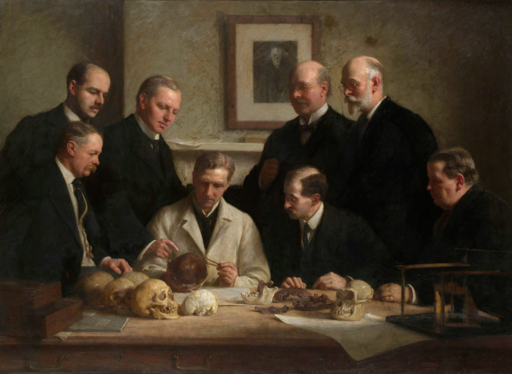 Group portrait of the Piltdown skull being examined. Back row (from left): F. O. Barlow, G. Elliot Smith, Charles Dawson, Arthur Smith Woodward. Front row: A S Underwood, Arthur Keith, W. P. Pycraft, and Ray Lankester. Painting by John Cooke, 1915
