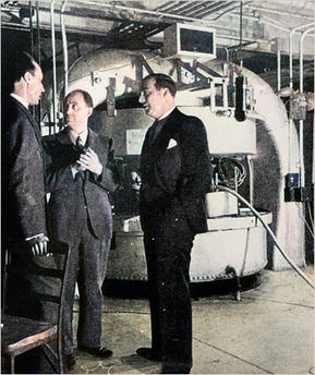 John Ray Dunning (1907-1975) - Photograph of he cyclotron built by Dunning in 1939, in the Pupin Hall physics building basement at Columbia University. Dunning (left) is with Enrico Fermi (center) and Dana P. Mitchell (right)