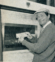 Actor Reg Varney using the world's first ATM in Enfield Town