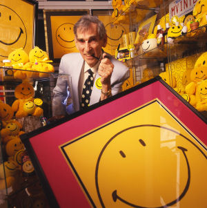 Ball posing with a selection of Smiley merchandising