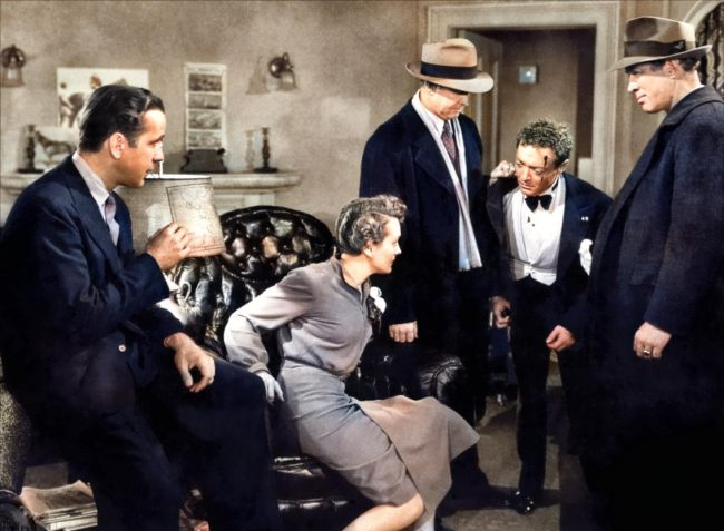 Dashiell Hammett, Promotional still from the 1941 film The Maltese Falcon, published on page 12 of National Board of Review Magazine. L-R: Humphrey Bogart, Mary Astor, Barton MacLane, Peter Lorre, Ward Bond